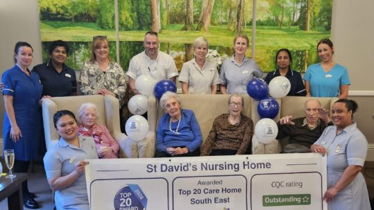 Award Winning Care Home 2026, residents and staff celebrating with banner