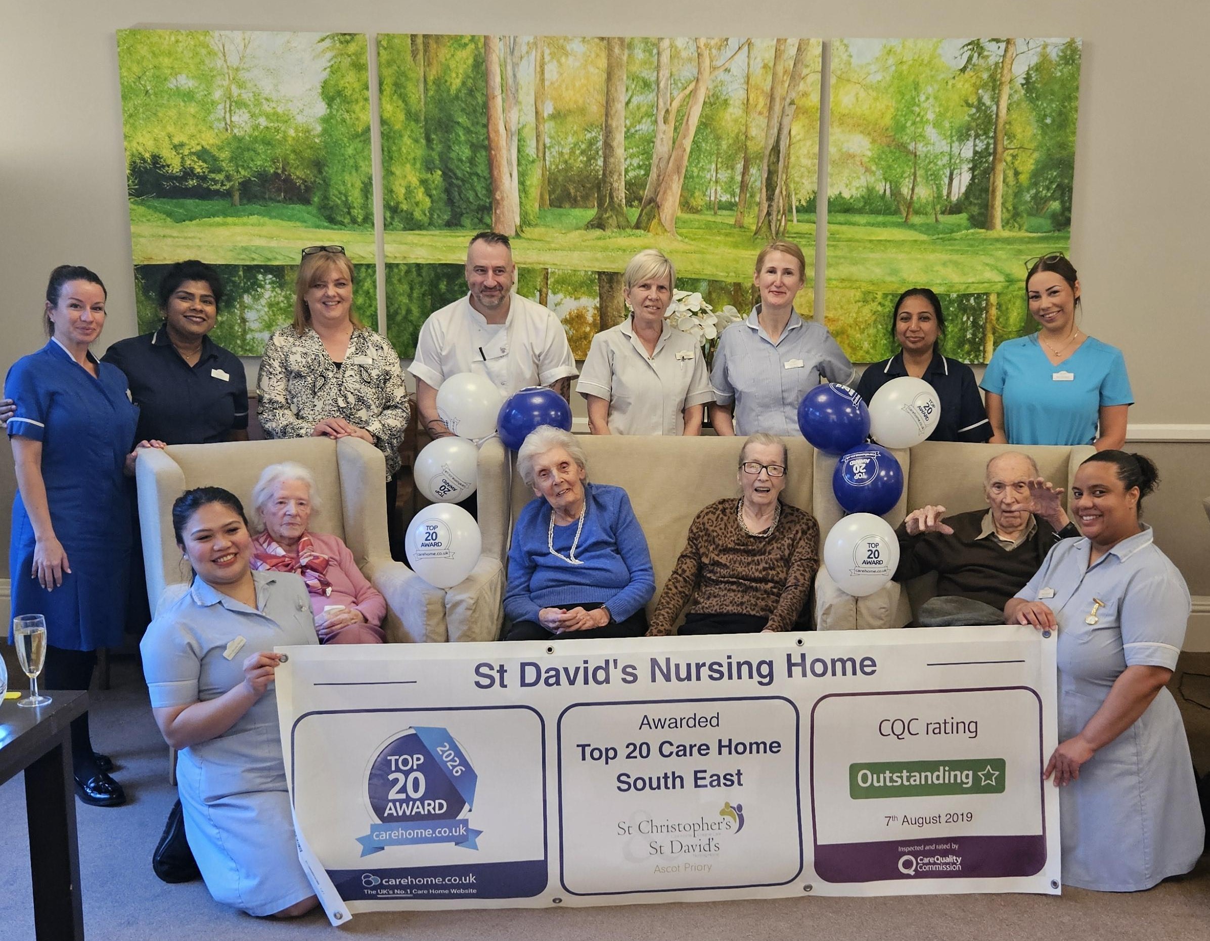 Award Winning Care Home 2026, residents and staff celebrating with banner